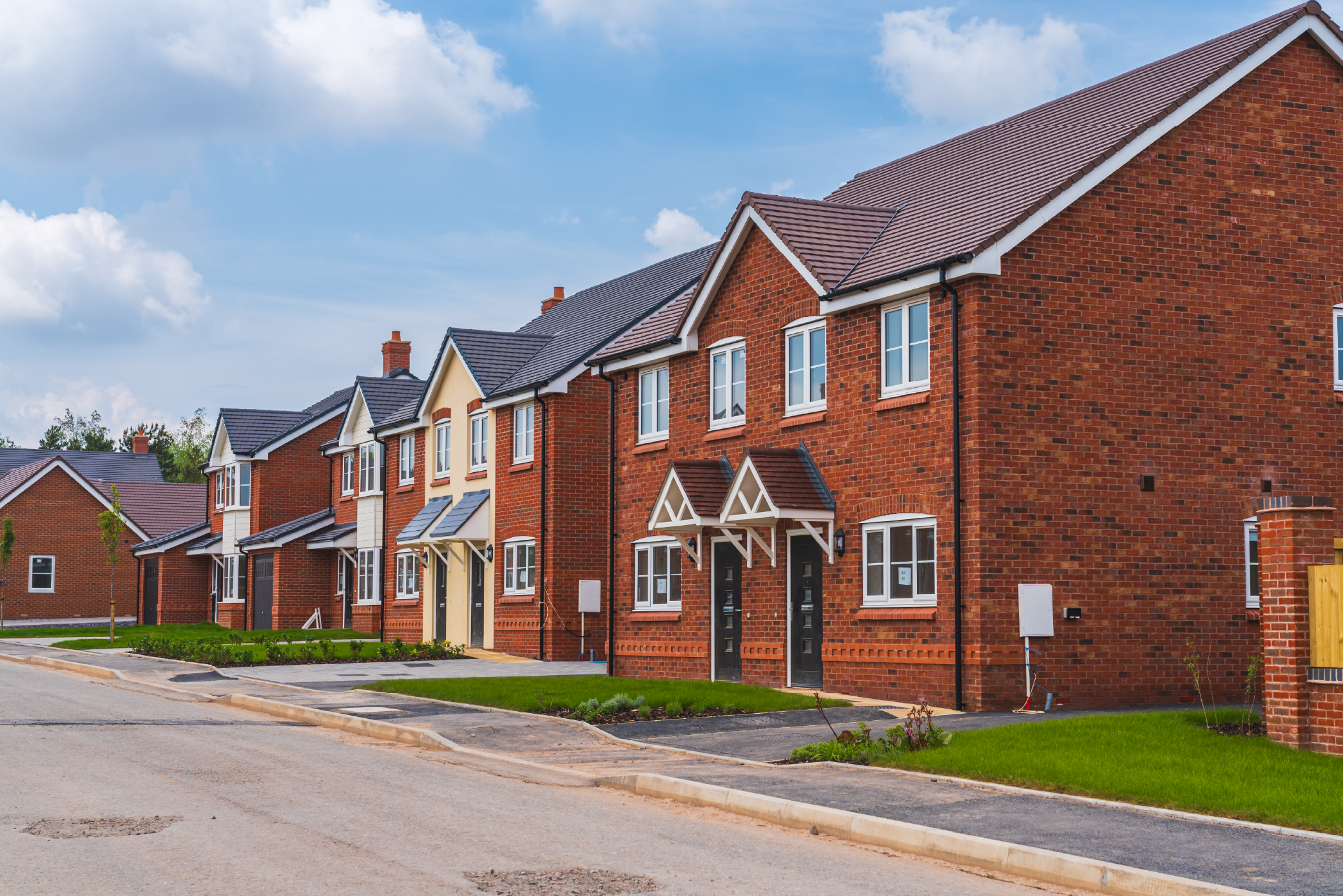 red brick residential housing in the UK from a view down the street